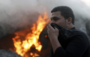 Palestinian in Gaza covers his mouth to avoid breaking Hamas' unilateral 72-hour cease-liar.